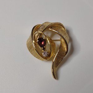 Gold Tone Asymmetrical Brooch With Purple Stone